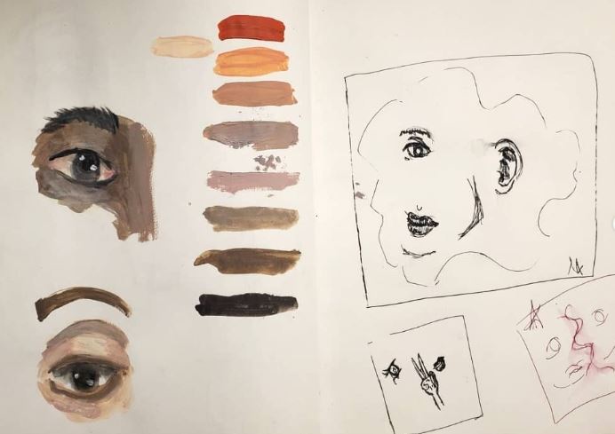 Sketchbook page with painted eye studies, skin-tone swatches, and expressive face drawings